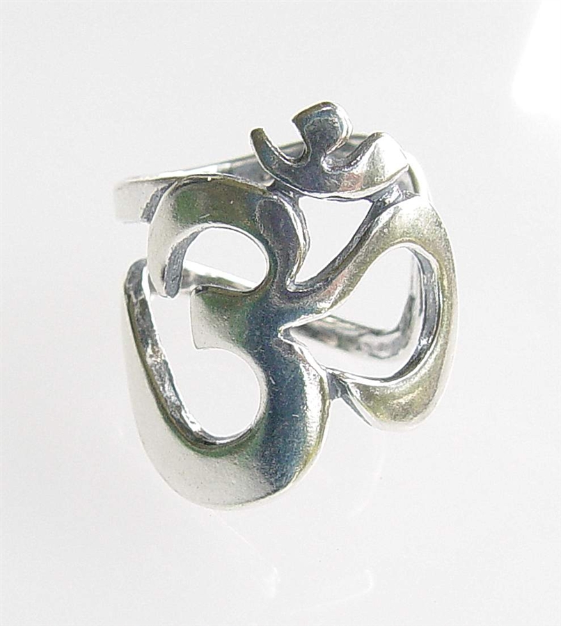Hand wearing elegant silver ring in oriental shape of om Stock Photo - Alamy