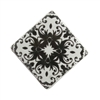 Square black and white ceramic cabinet knob with a floral motif.