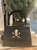 Women's black faille fabric top handle4 handbag with gold skull.