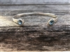 Sterling silver hammered bangle bracelet with blue topaz