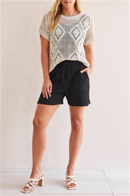 Cap sleeve crochet knit top in cream with black thread.