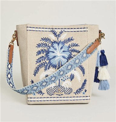 Khaki color jute and cotton bucket bag with blue embroidery on the front with an embroidered strap from Spartina 449.