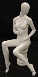Female Egghead Mannequin in Seated Pose. She has an abstract head.