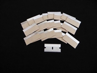 Large array of stainless steel single edge razor blades with paper edge protectors