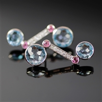 Imperial Icicle Earrings photo. Like the Imperial Icicle Ring, these are made from 18k white gold, giving it a special unique appeal. Two, round, shiny, blue topaz stones at each end and 2 smaller pink tourmalines along with the diamonds on the shaft.