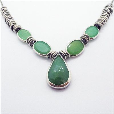 Vibrant Mint Necklace photo. Like the Lemongrass Drop necklace, its structure is silver, however this one is shorter. With a drop-like center chalcedony and other round chalcedonies on the sides. Detailed silver hoops come after the stones on the sides.