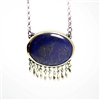 Bright blue lapis is set in bezel of 18k gold back with sterling silver.