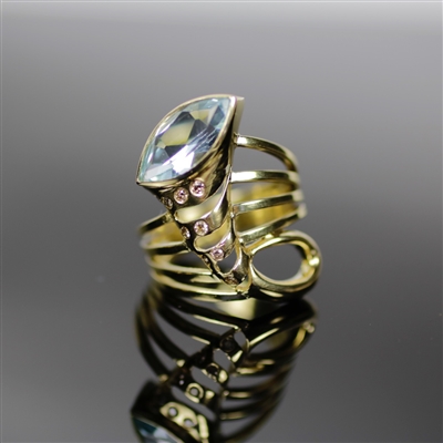 Clarion Cornucopia Ring photo. Beautifully structured cornucopia shape made out of the best 18K yellow gold, with a light blue topaz and little detailed chocolate diamonds. This is elegant and very unique!