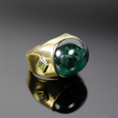 Dark Forest Ring photo. Gorgeous mix of 18k yellow gold and a darker green tourmaline, makes this piece very sophisticated. The center and top of the ring contains a round green tourmaline and one of the sides of has a detailed squared tourmaline as well.