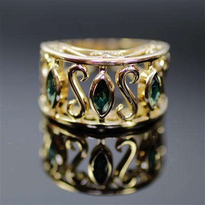Tuscany Ring photo. Just like its cousin, the Tuscany Bracelet, this 18k yellow gold ring contains the same leaf designs with the green tourmalines that bring in the Italian air of the mediterranean lands and ocean breeze.