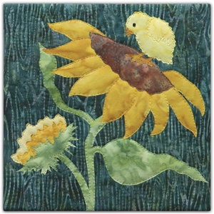 a fabric panel with a yellow chick standing on a large sun flower on a green background.