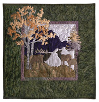 Quilt block showing elk, mountains, and trees