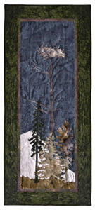 Quilt block of an eagle's nest atop a tree.