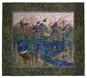 Quilt block of a man fishing in a river in the mountains, watched by an elk, with geese flying overhead.