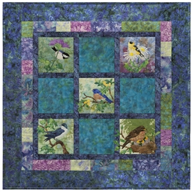 Pieced quilt block with appliqued morning birds.