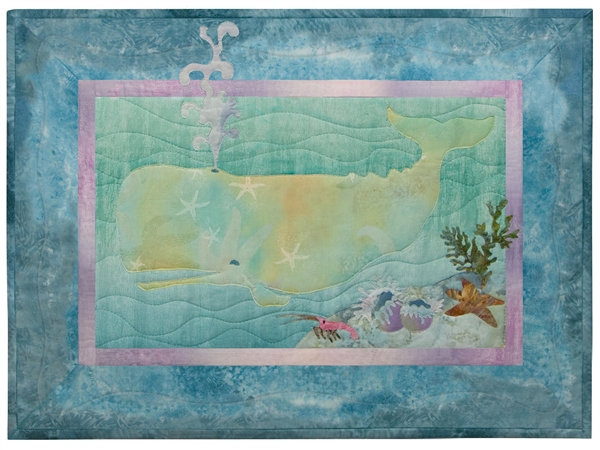 Quilt block of a frolicking sperm whale and group anemones, a starfish, and a little crab.