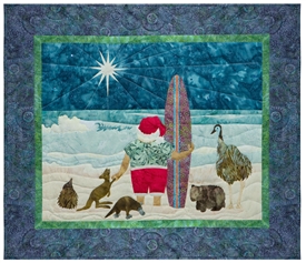 Quilt block of Santa on the beach with his surfboard, ready to ride the waves under the north star, with his Australian animal friends.