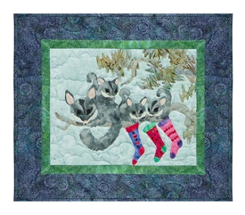 Quilt block of a family of sugar gliders hanging their stockings on the tree with care.