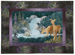 Quilt block of a doe with her fawn carefully drinking from the stream below a small waterfall.