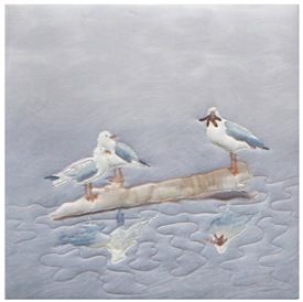 Quilt block of two seagulls on a log in the water, looking appraisingly at a third seagull, who has dinner...for now.