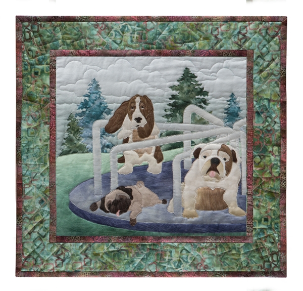Quilt block of a pug, a bull dog, and a basset hound getting dizzy on the merry-go-round.