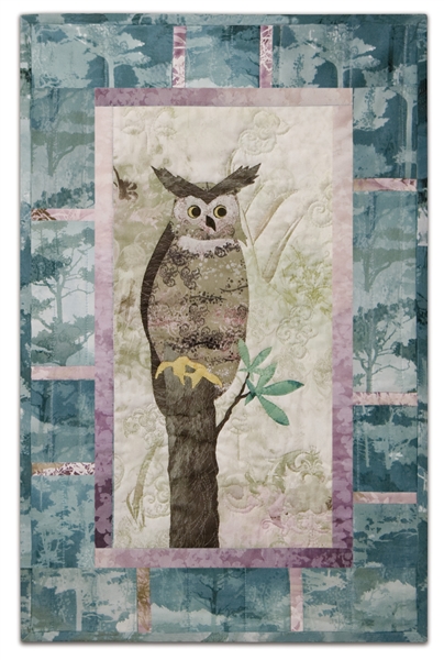 Quilt block of an owl sitting at the very top of a tree, watching the world