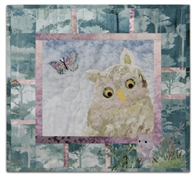 Quilt block of an owl claiming a mouse for lunch.