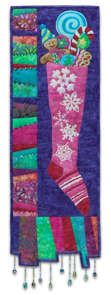 Quilt block of a Christmas stocking filled to the brim with candy and gingerbread cookies, with unique pieced border and dangling beaded accents
