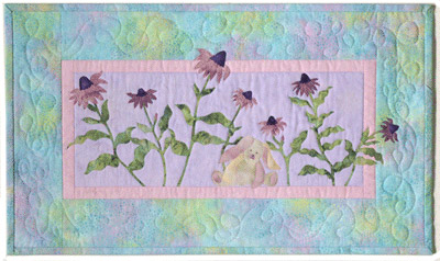 Quilt block of Bunny from block one taking a nap in a field of purple coneflower