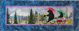 Mama bear riding her bike through the Portland country side with her babies in tow, one in the basket on the front of the bike and one on a wagon full of fabric in the back. Mount Hood, forest with flowers and city-scape in the background