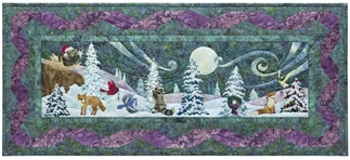 Quilt block of animals gathering by the light of moon to sing and celebrate the season.