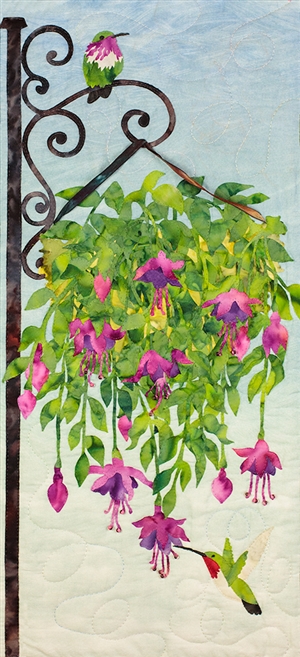 Fabric art print of hummingbirds drinking nectar from a hanging plant.
