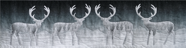 a single block quilt with an arctic snowy scene with caribou against a dark sky