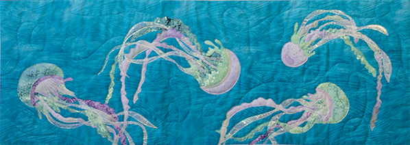 Quilt block of jellyfish dancing under the waves.