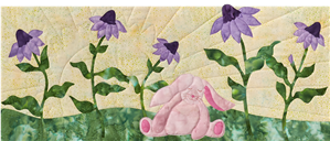 This little bunny sitting in a row of flowers is so happy that dreams really do come true.