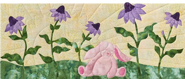 This little bunny sitting in a row of flowers is so happy that dreams really do come true.