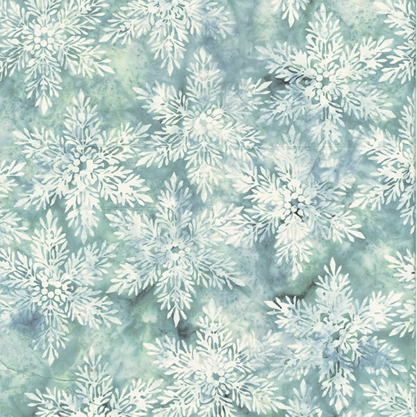 Batik fabric in snowflake print in pale blue/green tones