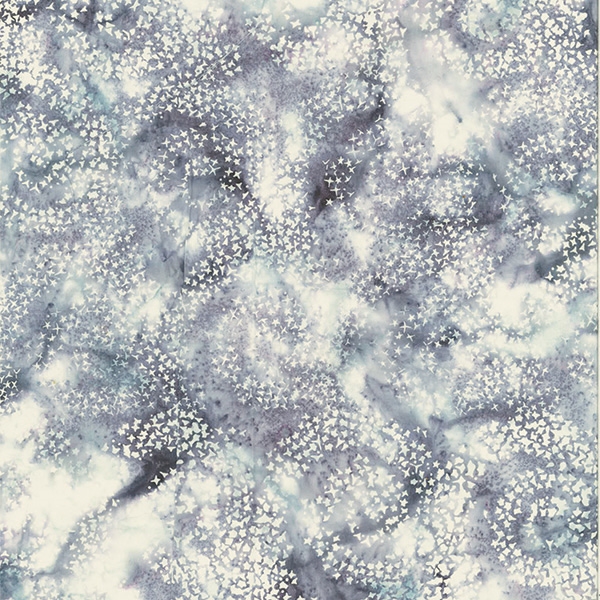 Batik fabric in a starry swirl print in pale purple and gray tones