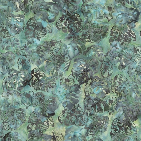 Batik fabric in monsteral leaf print in deep purple/blue on a background of blue and green