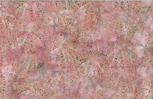 Batik fabric with a sea urchin print in coral pinks and oranges