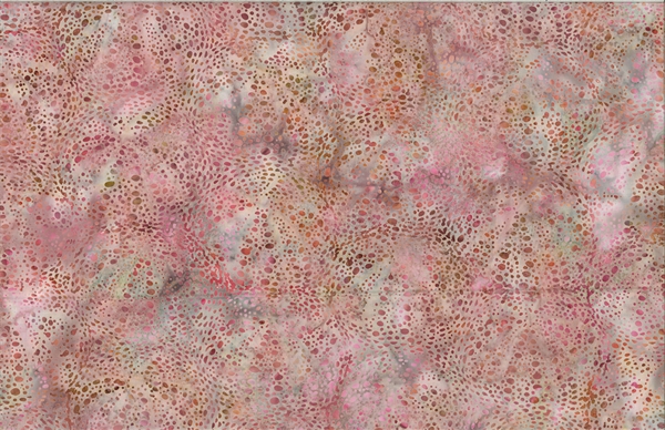Batik fabric with a sea urchin print in coral pinks and oranges