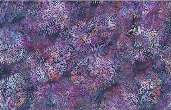 Batik fabric with a sea anenome print in purple with pink and orange accents