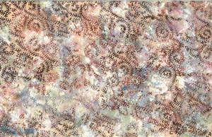 Batik fabric with a swirled seaweed print in pink, brown and pale blue tones