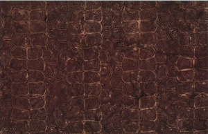 Batik fabric with a sea turtle skin print in reddish brown and burgundy tones