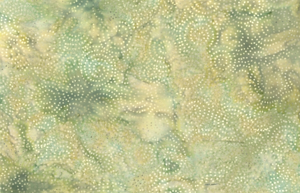 Spiral dot pattern batik fabric on a marbled yellow and green background.