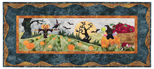 Kitten at the pumpkin patch, popping out of a pumpkin filled with candy. There is a scarecrow in the field and a spooky tree in the background under a harvest moon