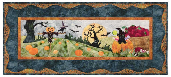 Kitten at the pumpkin patch, popping out of a pumpkin filled with candy. There is a scarecrow in the field and a spooky tree in the background under a harvest moon