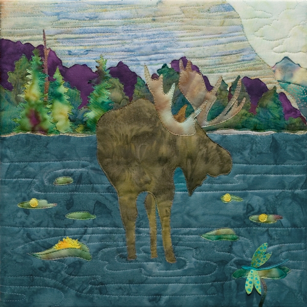 fabric panel with a moose munching his snack while wading in a lake or pond