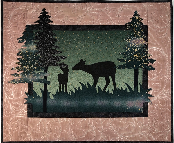 A pair of quilt blocks, one at dusk and one at dawn of a family of deer
