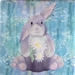 A floppy-eared Bunny holds daisies